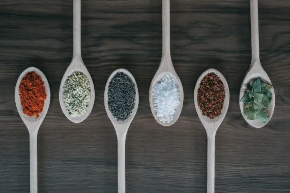 assorted-color spoons with spices